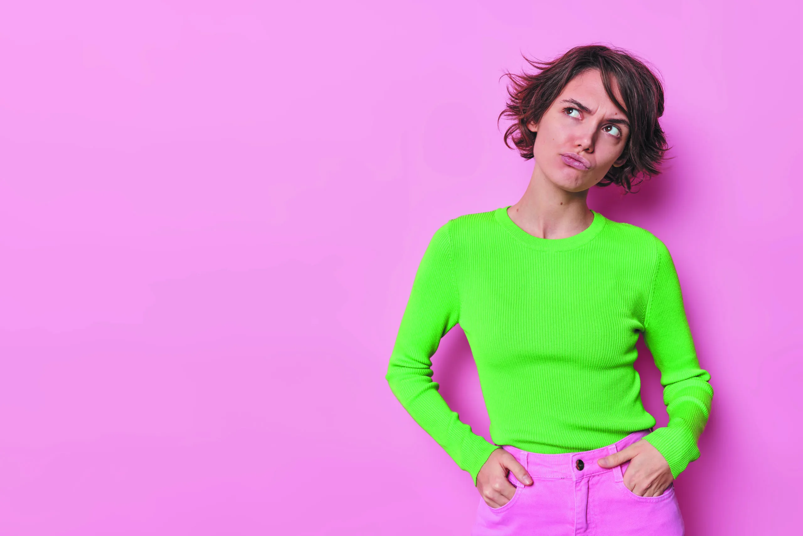 Studio,shot,of,thoughtful,young,woman,with,short,trendy,hairstyle